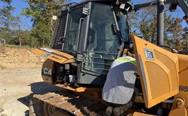 Field Service working on an excavator
