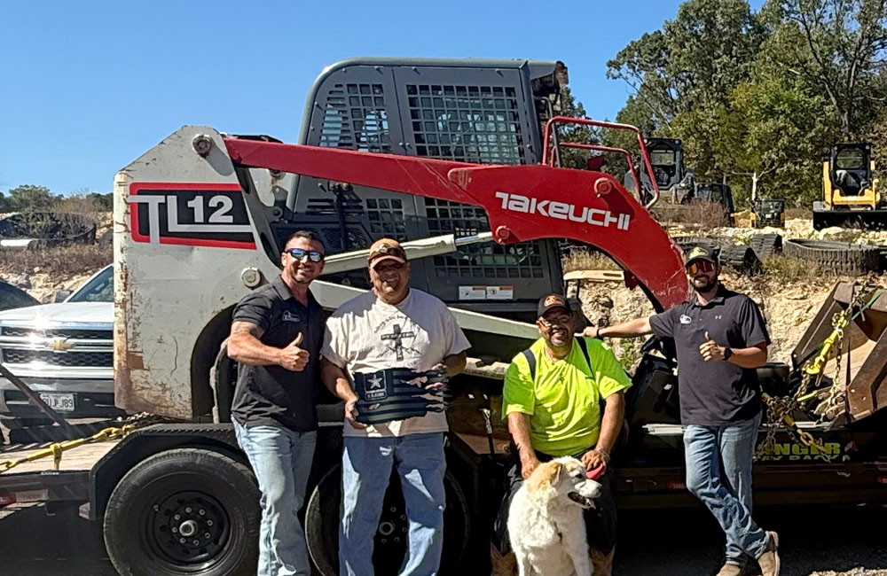 customers standing in front of a Skid steer Sale