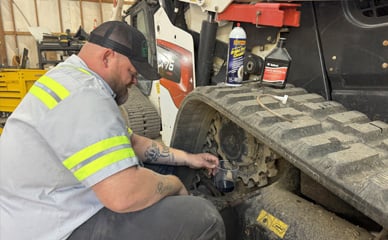 Shop Service team working on a skidsteer